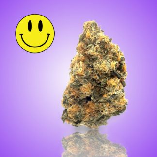 A close-up image of a crystal candy cannabis bud, showcasing its vibrant orange and green hues against a purple background, with a smiley face icon in the corner.